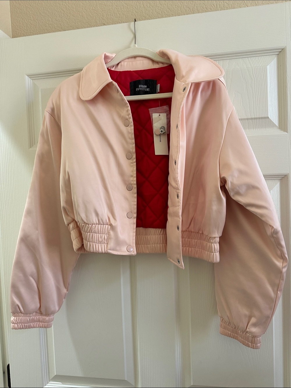Urban Outfitters Pale Pink Bomber Jacket with Red Quilted Lining